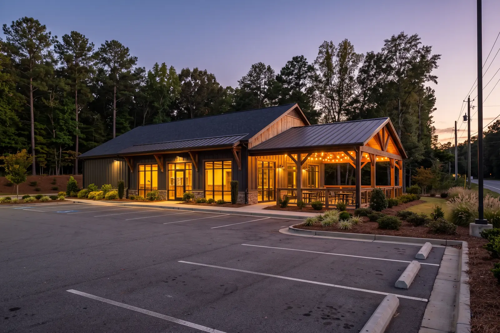 Illustrative image: a freestanding restaurant building with a covered patio and warm interior lights at dusk beside an empty parking lot.